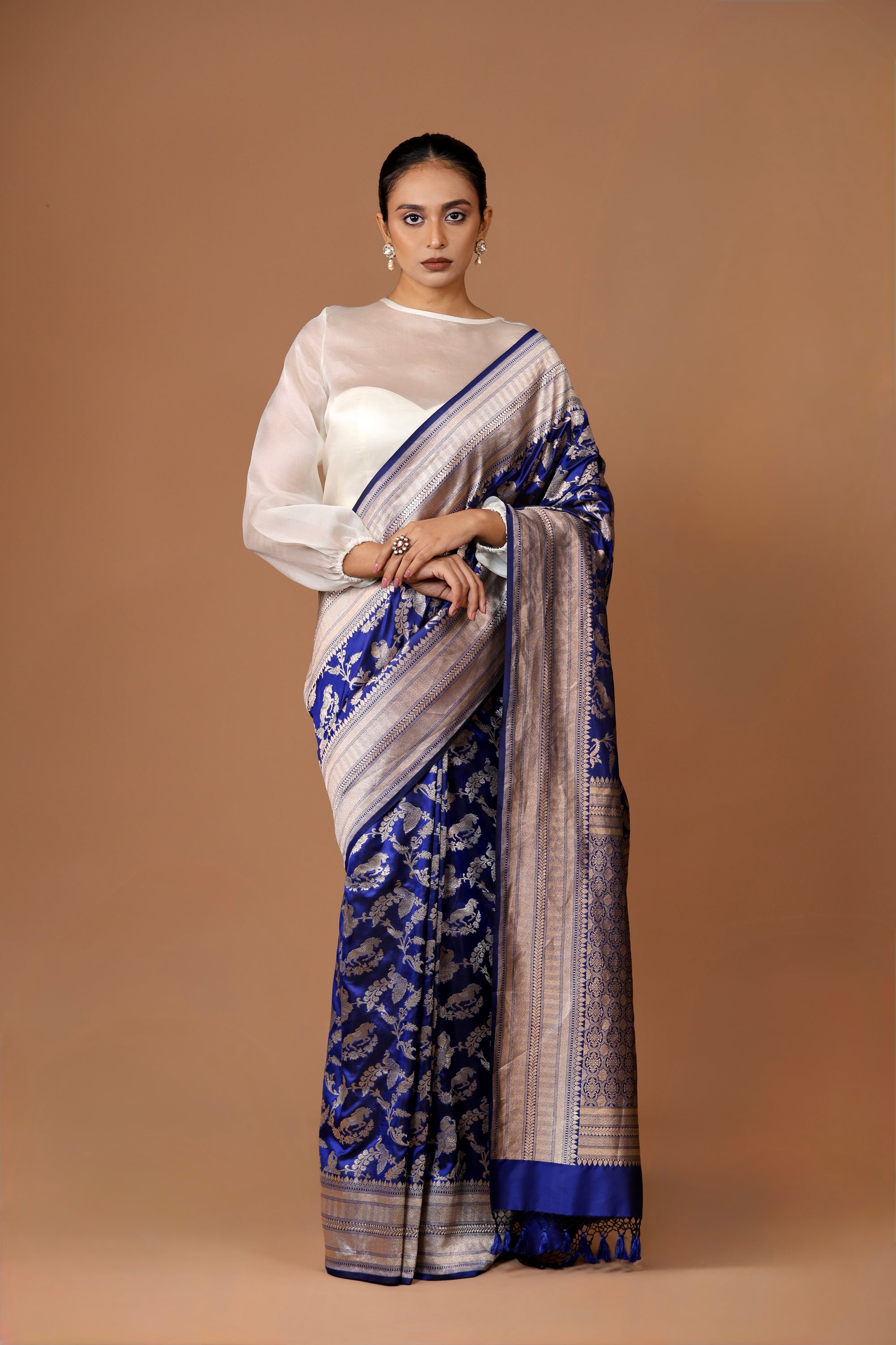 Banarasi handwoven Blue silk Shikargah sari adorned with intricate motifs and exquisite detailing.