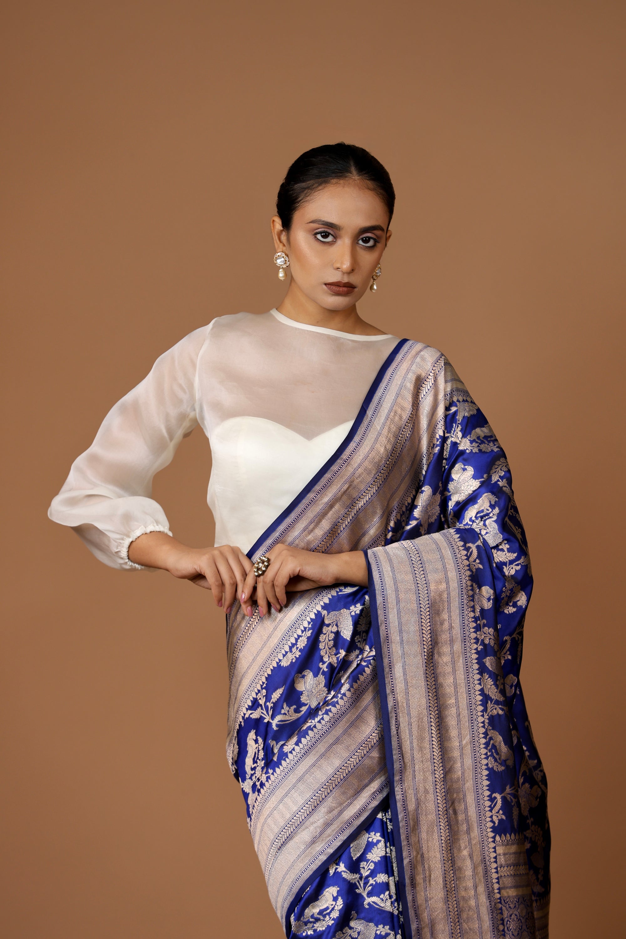 Banarasi handwoven Blue silk Shikargah sari adorned with intricate motifs and exquisite detailing.