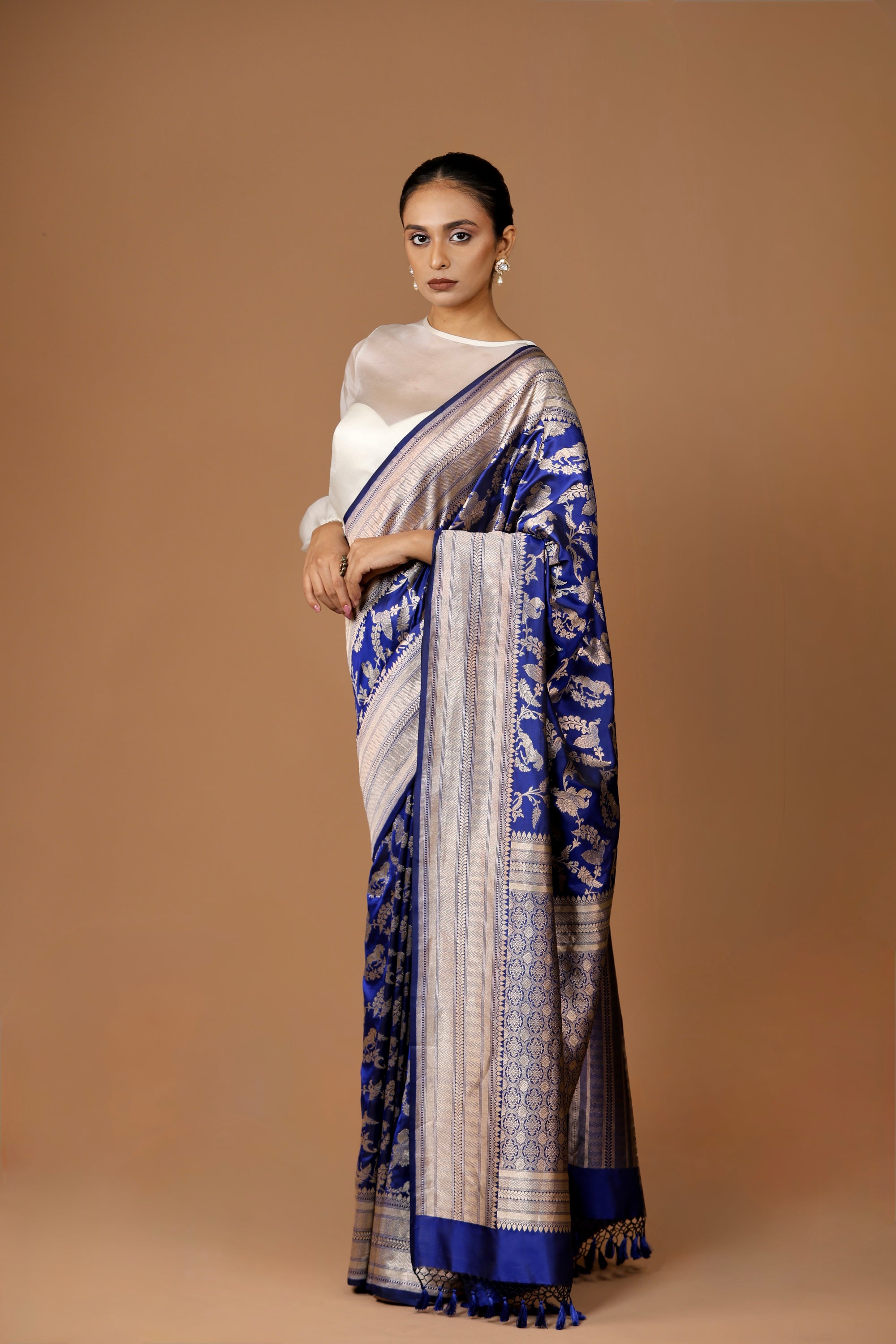 Banarasi handwoven Blue silk Shikargah sari adorned with intricate motifs and exquisite detailing.