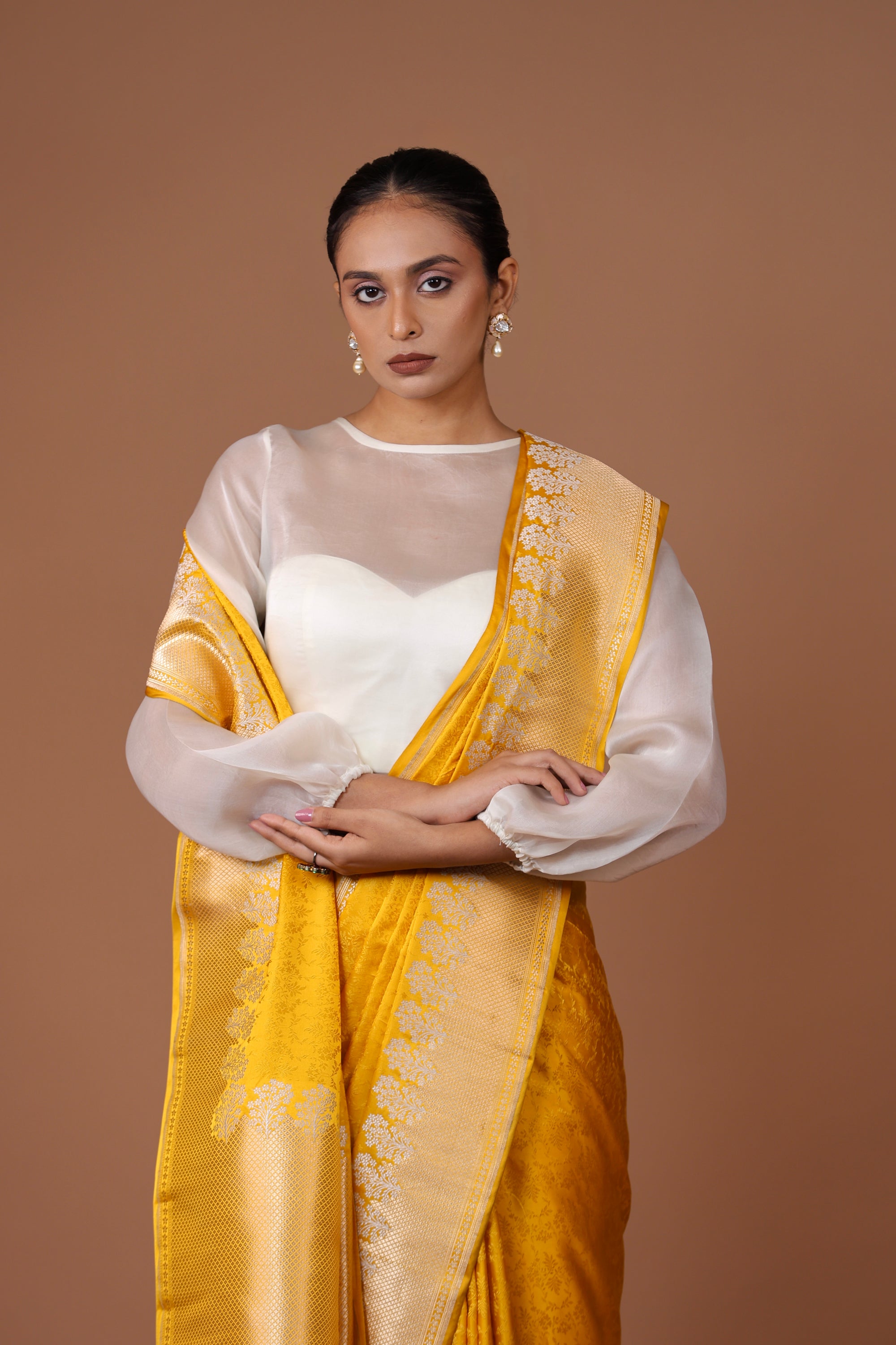 Radiant Banarasi handwoven Yellow silk Tanchoi sari with delicate woven patterns and refined elegance.