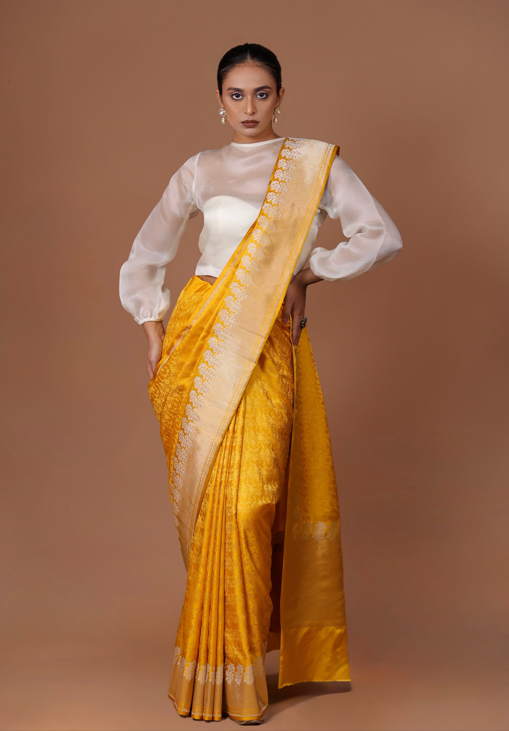Radiant Banarasi handwoven Yellow silk Tanchoi sari with delicate woven patterns and refined elegance.