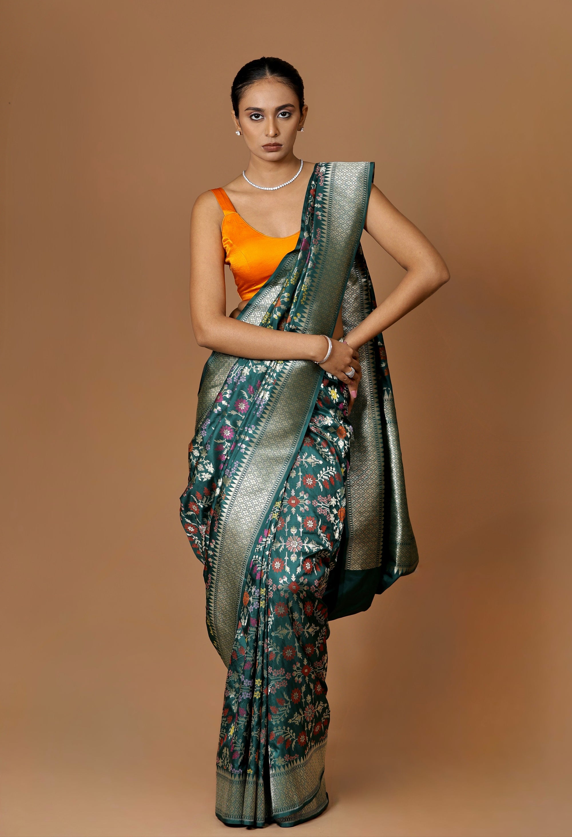 Banarasi handwoven green silk sari with intricate meenakari.