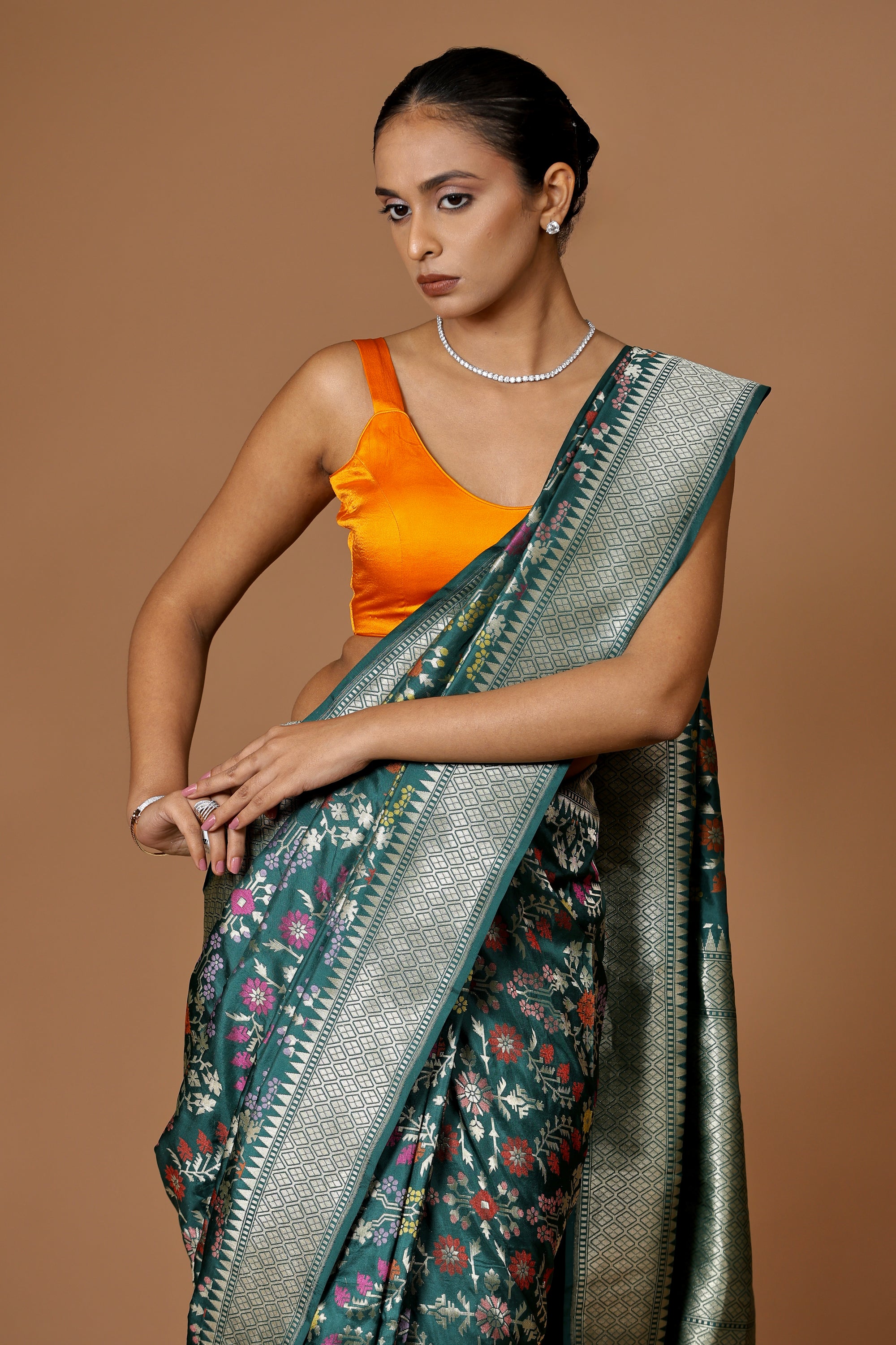Banarasi handwoven green silk sari with intricate meenakari.