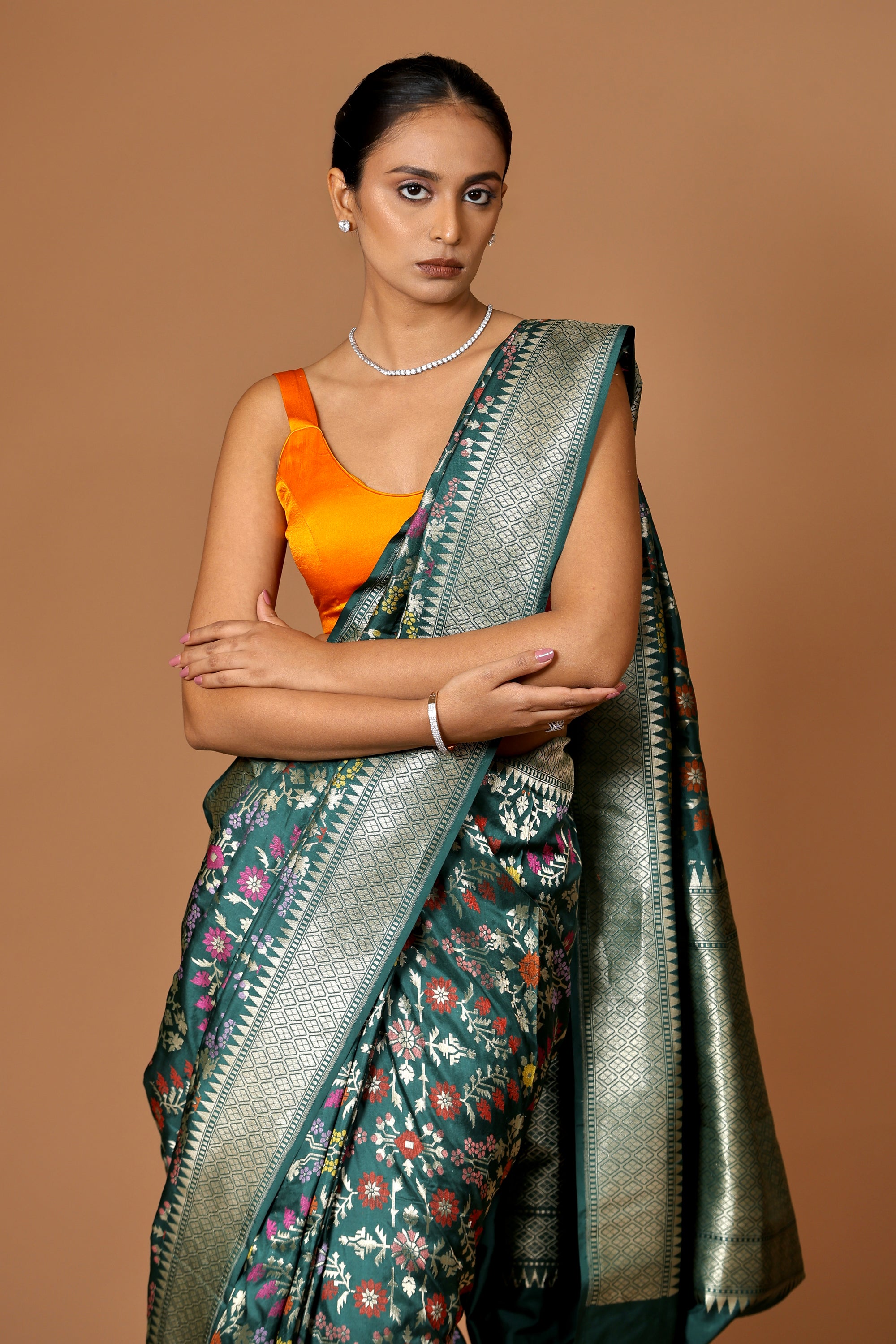 Banarasi handwoven green silk sari with intricate meenakari.