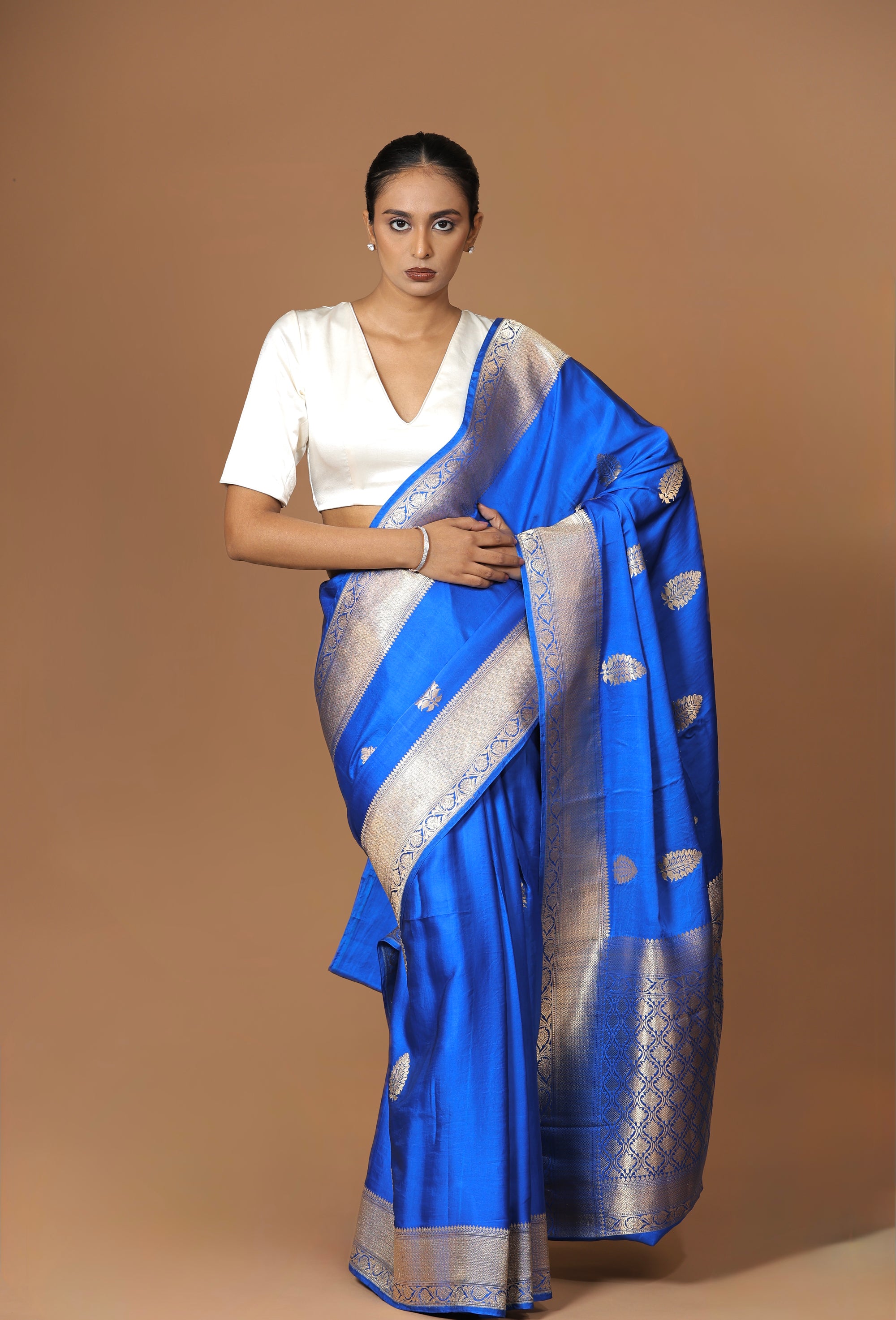 Banarasi handwoven blue satin silk sari with a lustrous, regal finish.
