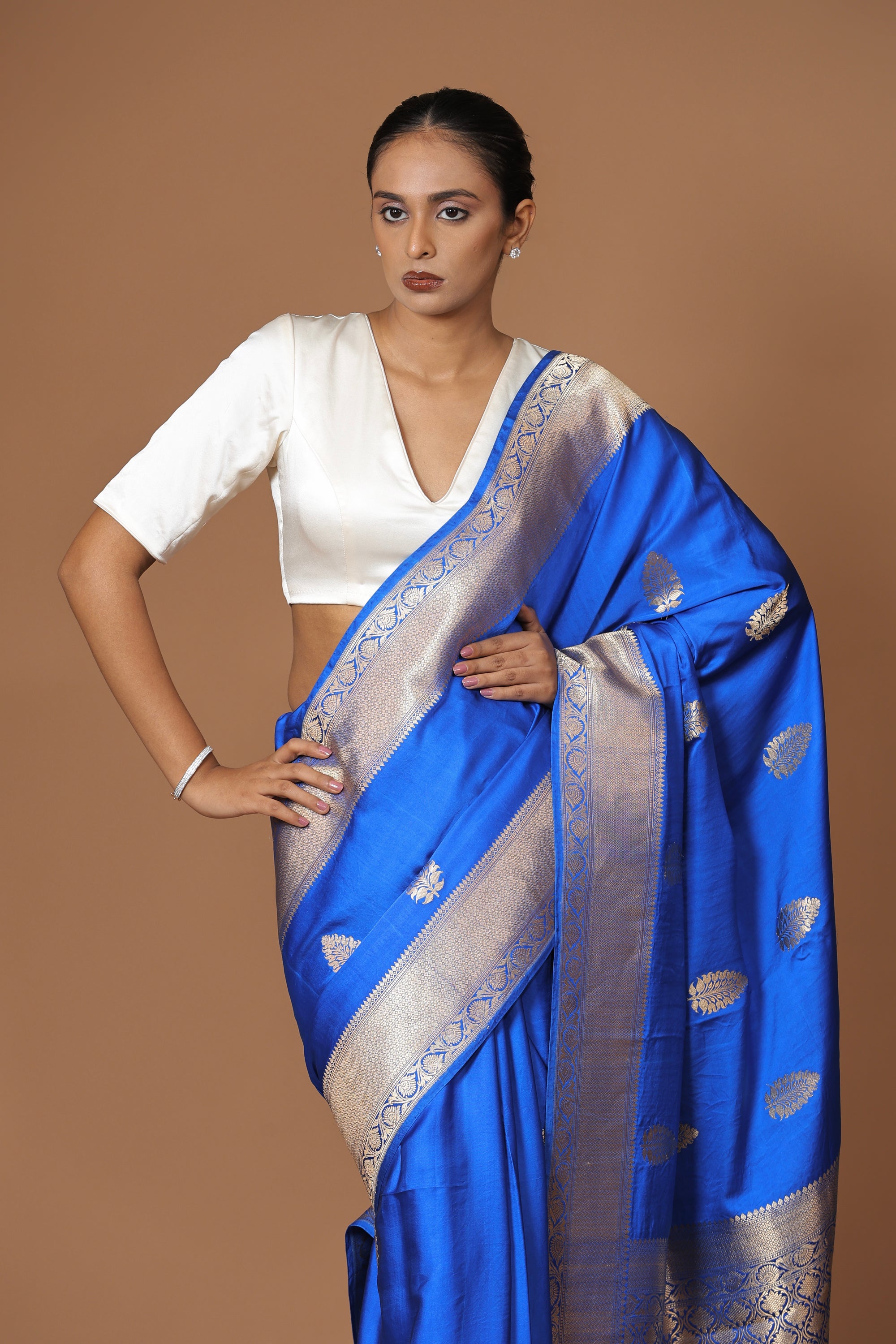 Banarasi handwoven blue satin silk sari with a lustrous, regal finish.