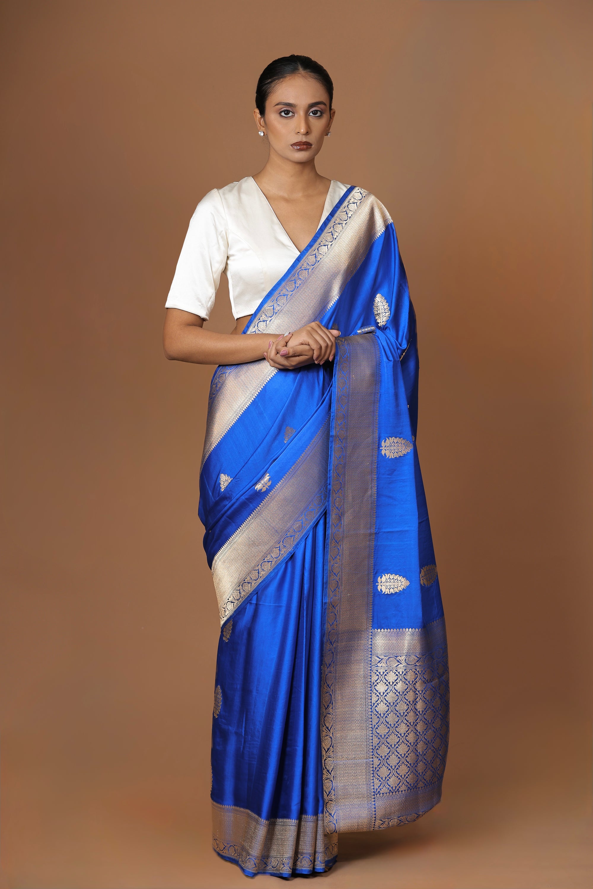 Banarasi handwoven blue satin silk sari with a lustrous, regal finish.