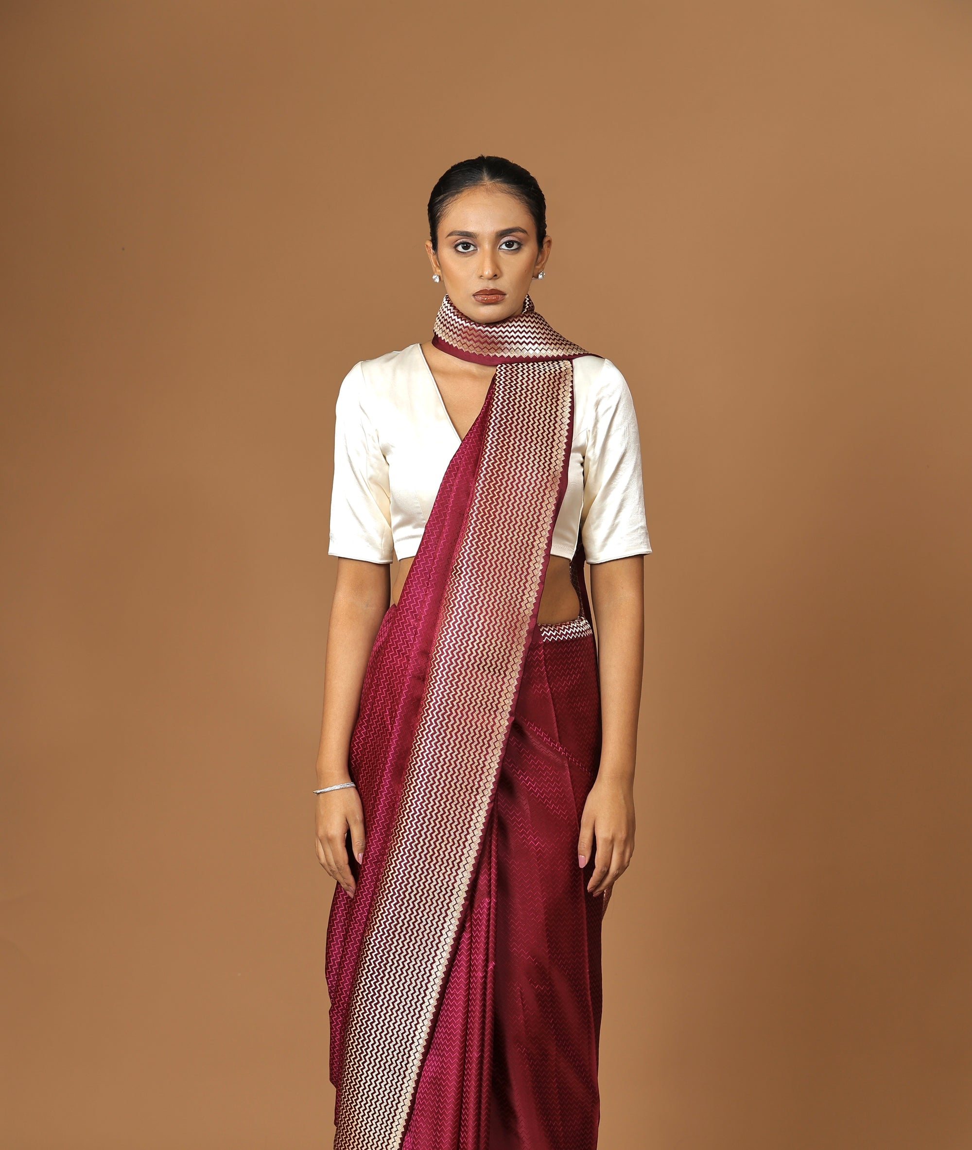 Exquisite Banarasi Tanchoi silk sari in deep Bordeaux, highlighted with a striking contrast border.