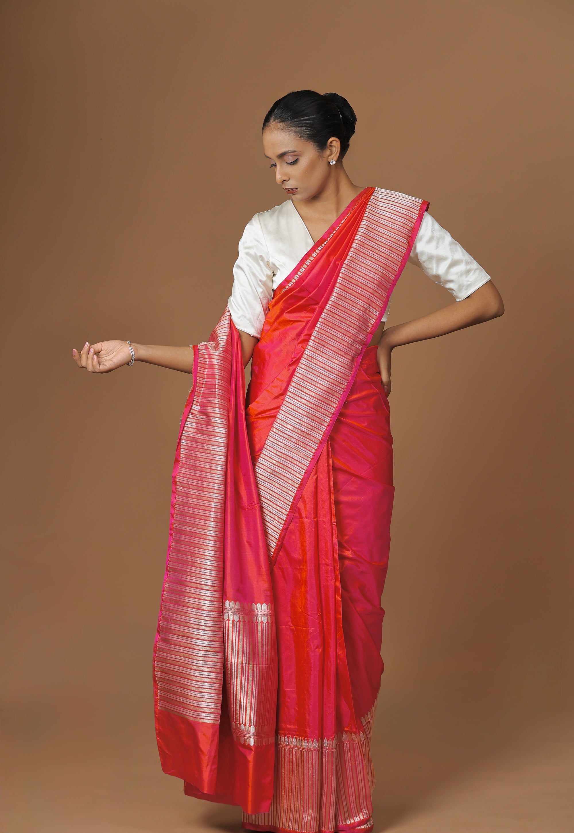 Radiant Banarasi handwoven fuchsia silk sari, highlighted with an intricately woven border.