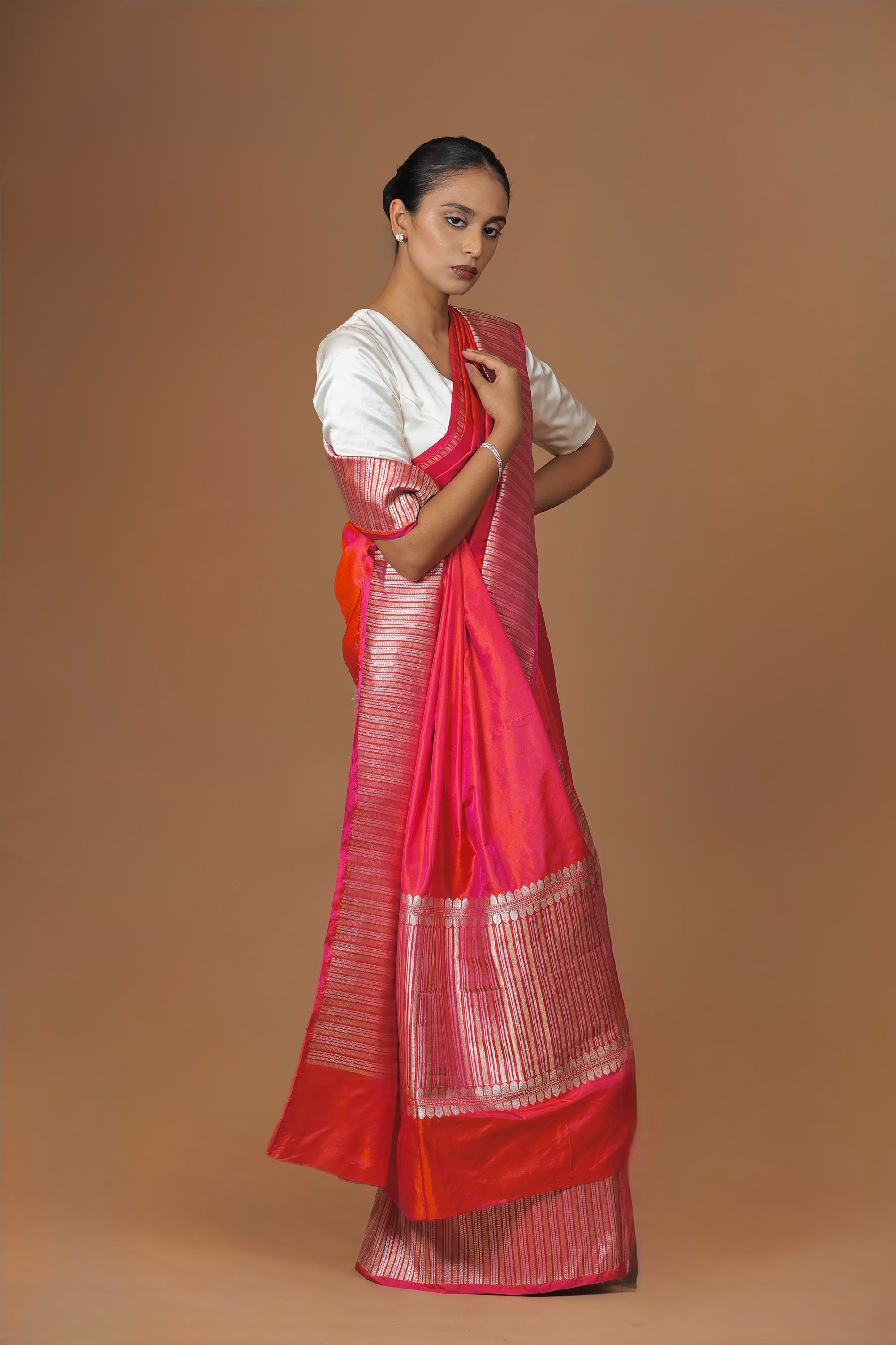 Radiant Banarasi handwoven fuchsia silk sari, highlighted with an intricately woven border.