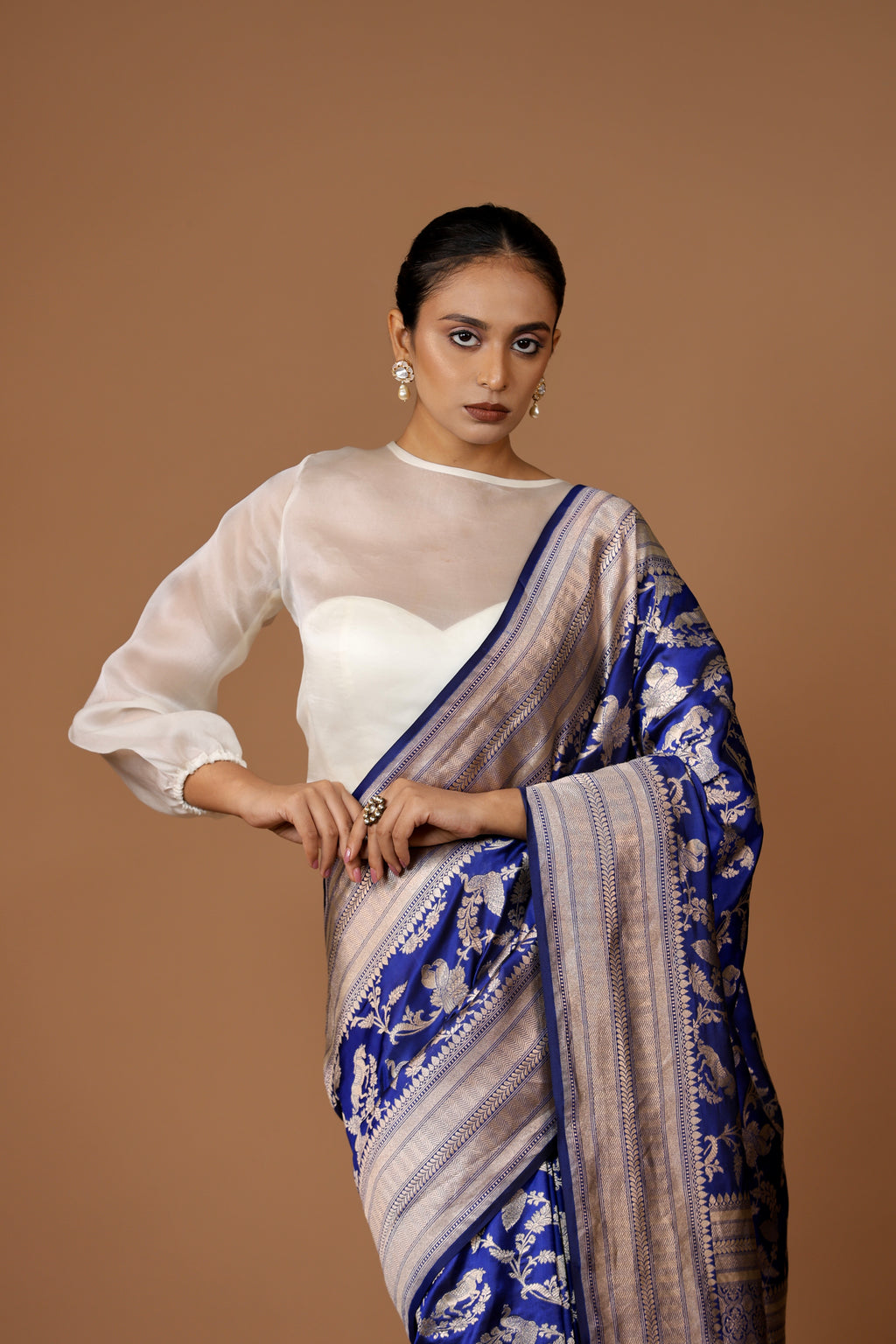 Banarasi handwoven Blue silk Shikargah sari adorned with intricate motifs and exquisite detailing.