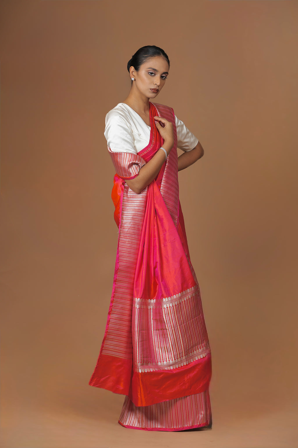 Radiant Banarasi handwoven fuchsia silk sari, highlighted with an intricately woven border.